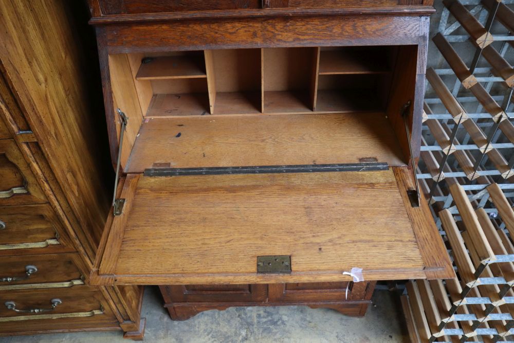 An Edwardian Arts & Crafts oak bureau bookcase, width 70cm, depth 34cm, height 196cm